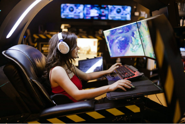 A woman is playing games on her PC