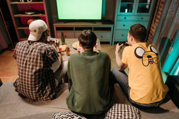 Three people sitting together and playing eSports